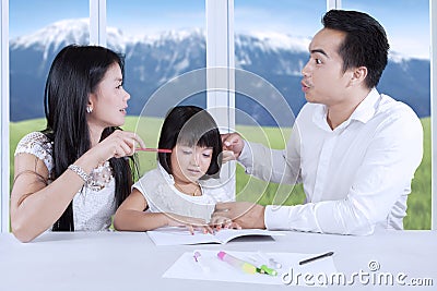Asian parents arguing in front of their child Stock Photo