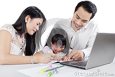 Asian parents teach their child to write Stock Photo