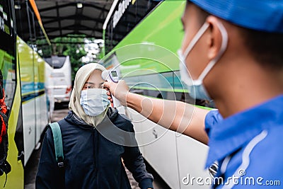 Passenger temprature check using thermogun Stock Photo