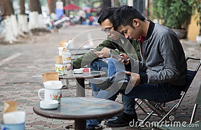 Asian people drinking coffee on the sidewalk Editorial Stock Photo