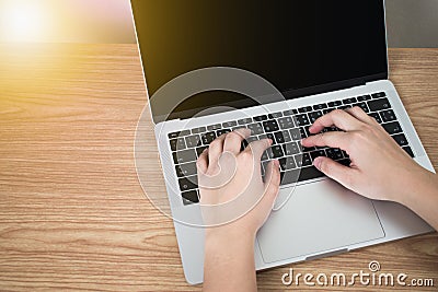 Asian people use a laptop computer on a brown wood desk. Black screen Stock Photo