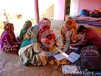 Asian poor women repaying loan installment on microfinance bank in india January 2020 Editorial Stock Photo