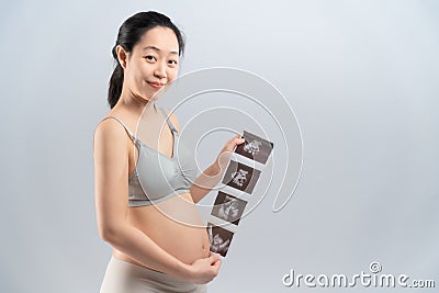 Asian pregnant smile woman and ultrasound film Stock Photo
