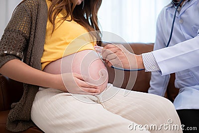 Asian pregnant woman visit gynecologist doctor at medical clinic for pregnancy consultant. Stock Photo
