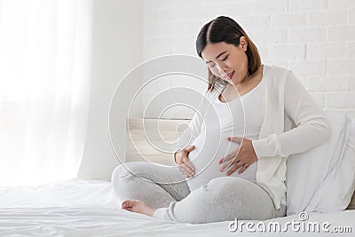 Asian pregnant women happy during pregnancy in the bedroom, Happiness and feel joyful as emotional well affect to baby Stock Photo