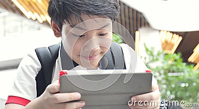 Asian preteens watching on tablet computer , smile face Stock Photo