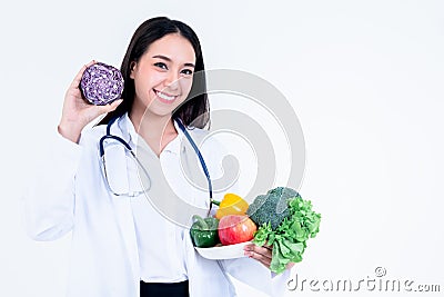nutritionist holding and showing many fresh vegetables and fruit Stock Photo