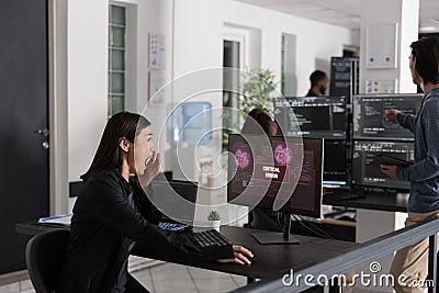 Asian it programmer reading critical errors on computer display Stock Photo