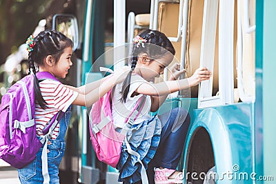 Asian pupil kids with backpack holding hand and going to school Stock Photo