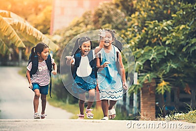 Asian pupil kids with backpack running Stock Photo