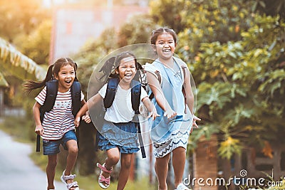 Asian pupil kids with backpack running Stock Photo