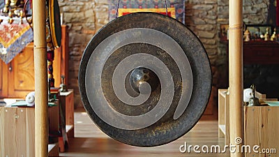 Asian religious metal gong to alert monks of prayer time - religion, tradition and lifestyle concept Stock Photo