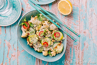 Asian salad with roasted cauliflower, cucumber, onion and chili Stock Photo