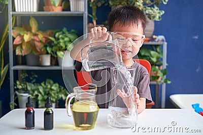 Asian school kid studying science, making DIY Lava Lamp Science Experiment, Kid-friendly fun and easy science experiments at home Stock Photo