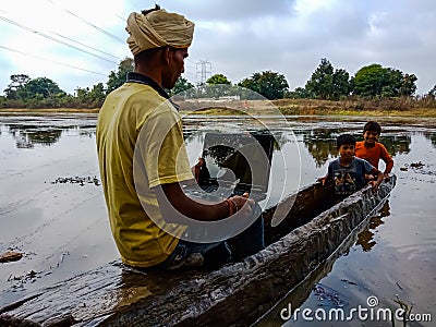 indian fisher man holded laptop on boat ride in India January 2020 Editorial Stock Photo