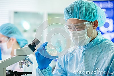 Asian scientist take petri dish Stock Photo