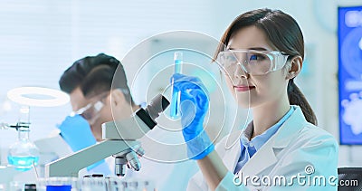 Asian scientist take test tube Stock Photo