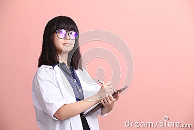 Asian scientist taking note on tablet Stock Photo