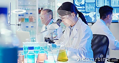 Asian scientist use microscope Stock Photo