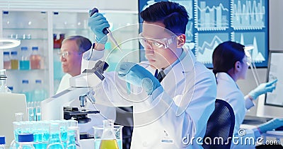 Asian scientist use microscope Stock Photo