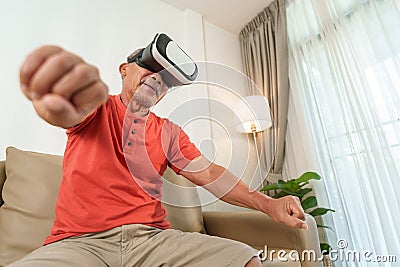 Asian Senior chinese man is using VR glasses Stock Photo