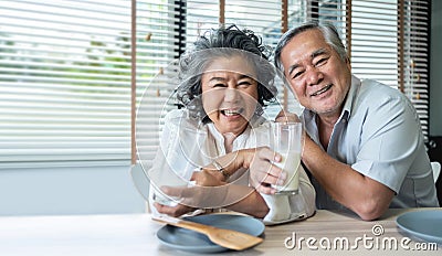 Asian Senior Couple drinking milk together. Stock Photo