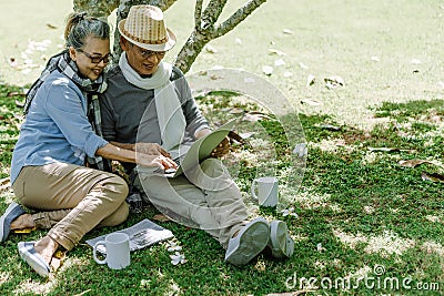 Asian senior couple or elderly people siting at garden Stock Photo