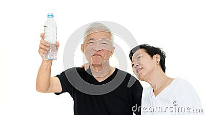 Asian Senior couple holding water bottle stay hydrate for health Stock Photo