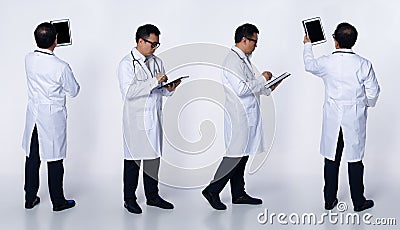Asian Senior Doctor full length look at tablet patient chart isolated Stock Photo