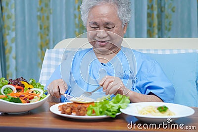 Asian senior or elderly old lady woman patient eating breakfast vegetable healthy food Stock Photo