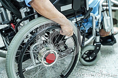 Asian senior or elderly old lady woman patient on electric wheelchair with remote control at nursing hospital ward. Stock Photo