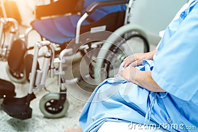 Asian senior or elderly old lady woman patient sitting on bed with wheelchair in nursing hospital ward : healthy strong medical co Stock Photo