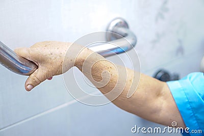 Asian senior or elderly old lady woman patient use toilet handle security in nursing hospital Stock Photo