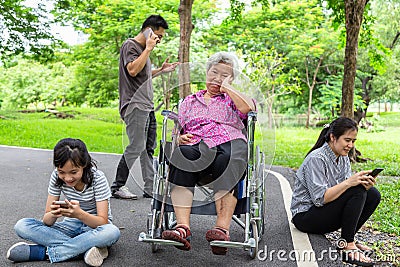 Asian senior grandmother is being ignore from family,elderly bored,sad,frustrated,disregard,parents,child girl with internet, Stock Photo