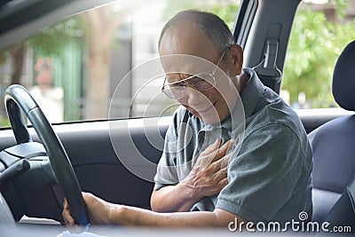 Asian Senior man having heart attack. Stock Photo