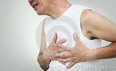 Asian senior man having heart attack while working out on white Stock Photo