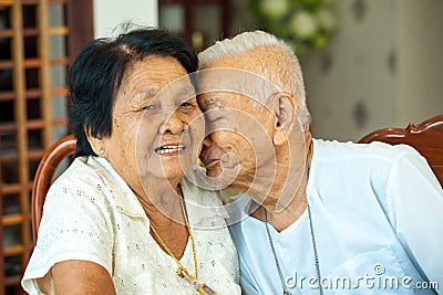 Asian Senior man kissing senior woman Stock Photo