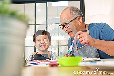 Asian Senior man and little boy Enjoying painting Stock Photo
