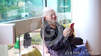 Asian senior man using smartphone outside in public space store happy connecting together Stock Photo