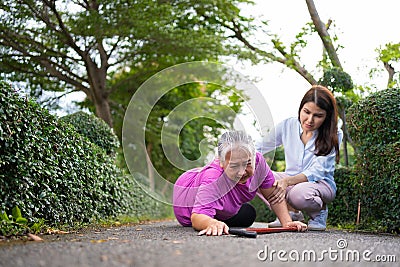 Asian senior woman fell down on lying floor because faint and limb weakness and Crying in pain form accident and her daughter came Stock Photo