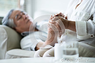 Asian Senior woman holding hands her husband Stock Photo