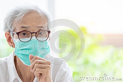 Asian senior woman suffer from cough with face mask protection,elderly woman wearing face mask because of air pollution,Sick old Stock Photo