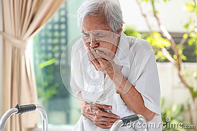 Asian senior woman suffering from abdominal bloating,colic in abdomen,flatulence,accumulation of gas,frequent belching,old elderly Stock Photo