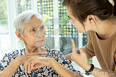 Asian senior woman is confused because she can not remember the face of their family or forget her daughter,memory loss in elderly Stock Photo