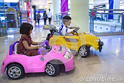 Asian sibbling riding car Stock Photo