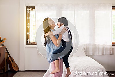 Asian single mom carrying her cheerful daughter at home,Happy and funny Stock Photo
