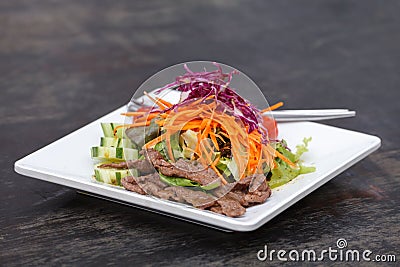 Asian Sliced Beef Salad with red cabbage and Carrots Stock Photo