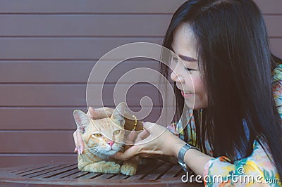 Asian smile woman playing a cat with love Stock Photo