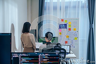 Asian software developer discussion about coding project on computer screen at moden office Stock Photo