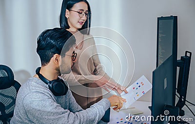 Asian software developer discussion about coding project on computer screen at moden office Stock Photo